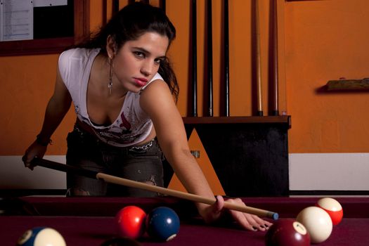 Detail view of a girl next to a snooker table.