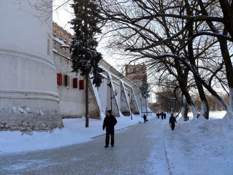 Moscow, Russia - February 23, 2010: Winter day. Peoples walks near fort in Novodevichiy monastery in Moscow, Russia