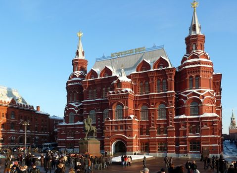 Moscow, Russia - February 23, 2010: Winter day. Peoples walks near national historic musium in Moscow, Russia