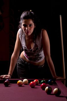 Detail view of a girl next to a snooker table.