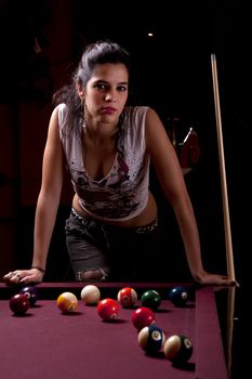 Detail view of a girl next to a snooker table.