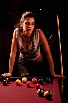 Detail view of a girl next to a snooker table.