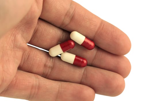 Pills in hand isolated in white