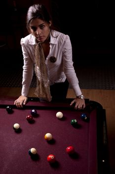 Detail view of a girl next to a snooker table.