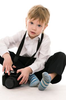 The child in a white shirt with the camera isolated on white background