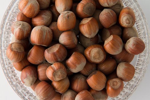 Top view of hazelnuts in glass bowl