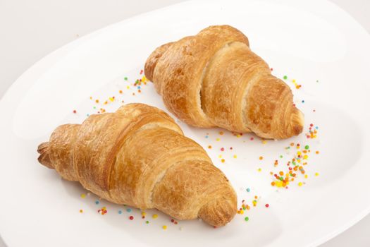 food series: two tasty fresh croissant on glassy plate