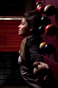 Detail view of a girl next to a snooker table.