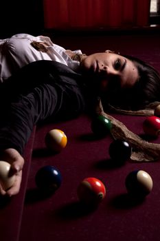 Detail view of a girl next to a snooker table.