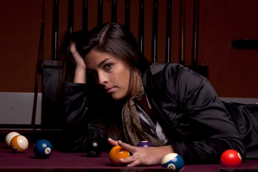Detail view of a girl next to a snooker table.