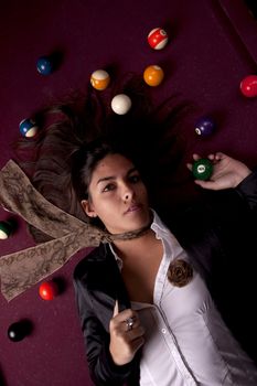 Detail view of a girl next to a snooker table.