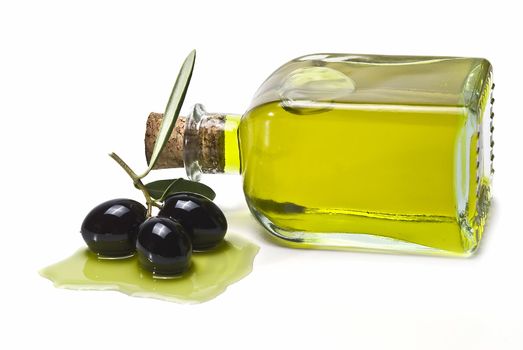 Some olives and olive oil isolated on a white background.