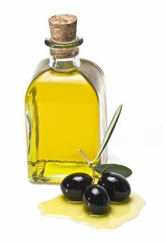 Some olives and olive oil isolated on a white background.