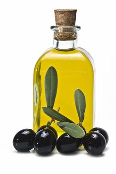 Some olives and olive oil isolated on a white background.