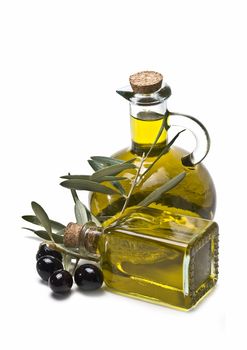 Some olives and olive oil isolated on a white background.