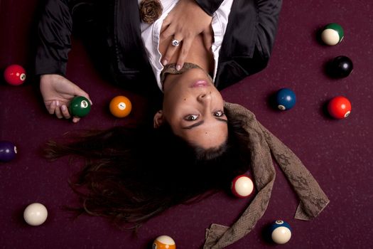 Detail view of a girl next to a snooker table.