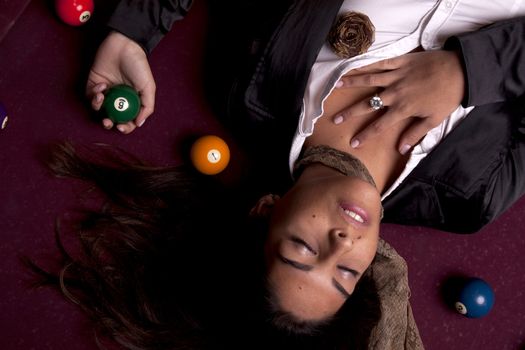 Detail view of a girl next to a snooker table.