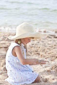 people series: little girl on sea beach are play the sandy game