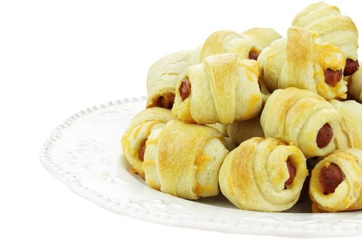 Plate of sausage rolls isolated on a white background.
