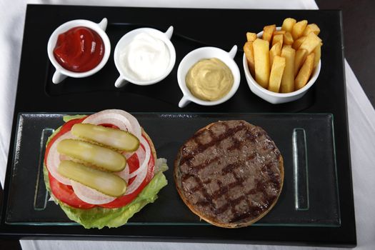 Burger, french fries and sauces from top view