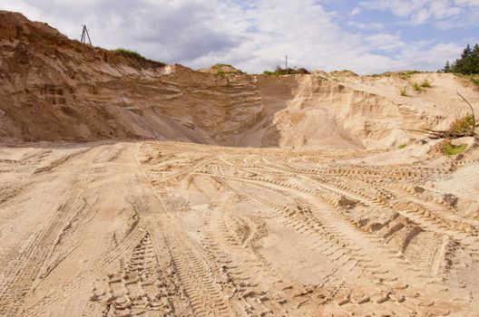 Sand pit. Sand special for construction. Pit full of fine sand and truck tracks.