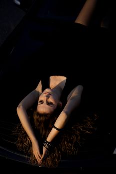 view of a beautiful woman on top of a sports car.