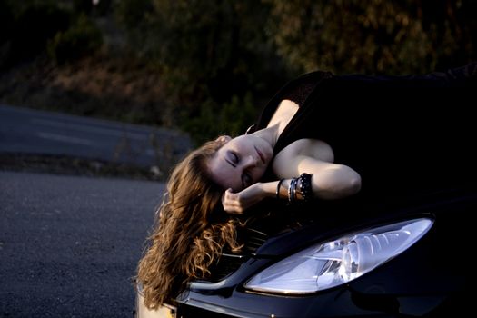 view of a beautiful woman on top of a sports car.