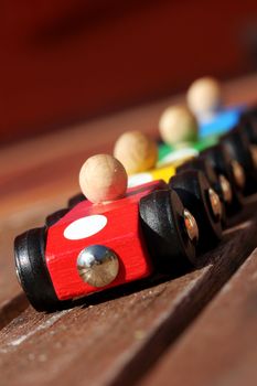 four wooden racing cars in starting position