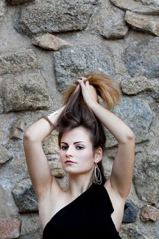 View of a beautiful girl on a black dress on a park.