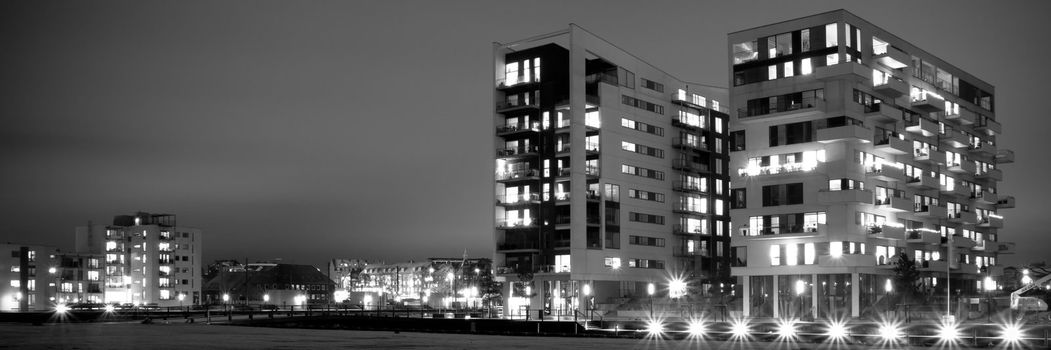 Modern residential buildings at harbour. Black and white.