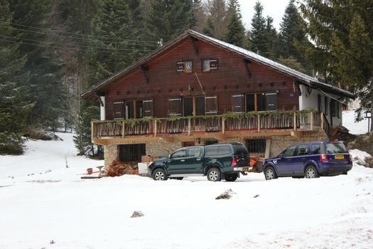chalet and snow and cars