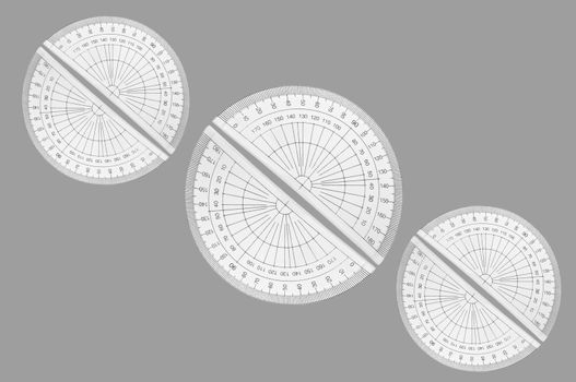 Several plastic protractors arranged in formation over light grey.
