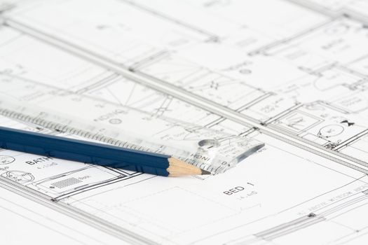 An architect's new building plan with ruler and blue pencil.