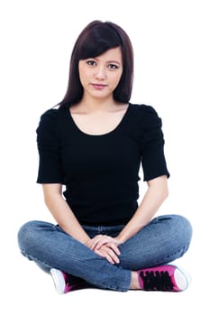 Portrait of an attractive young Asian woman sitting on the floor over white background.