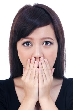 Portrait of a shocked young female covering mouth with her hands, isolated on white background.