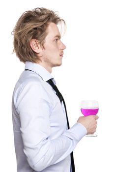 Young man holding a glass of pink wine. Studio photo of blonde man on white background.