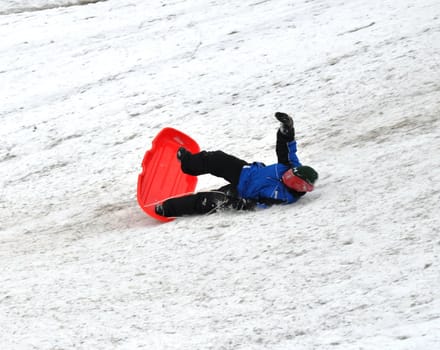 sledding and falling down the hill