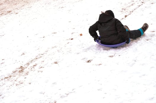 sledding down backward