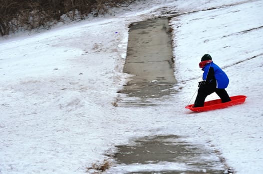 sledding near the sidewalk