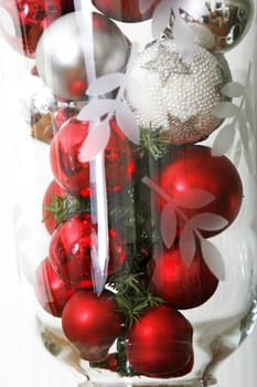 Christmas theme - Red and white Christmas balls in a large glass
