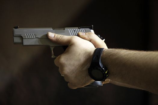 Man's hands with a pistol