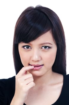 Portrait of a beautiful young Asian woman biting her finger, isolated on white.