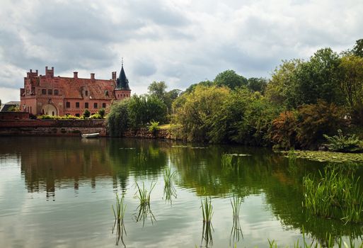 Beautiful view on medieval castle across the pond