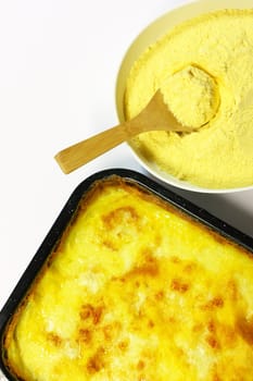 Fresh cooked polenta with corn meal isolated on white