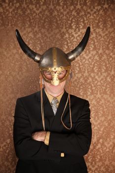 Businessman in dark suit and viking helmet