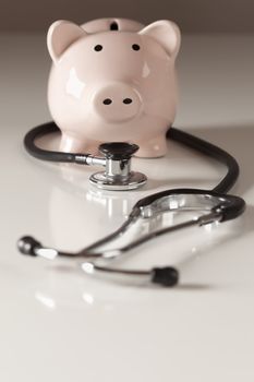 Piggy Bank and Stethoscope with Selective Focus on a Gradated Background.