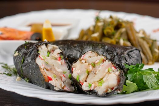 souffle of fillet of pikeperch, shrimps, crab meat, coconut and leek wrapped at nori garnished by string beans
