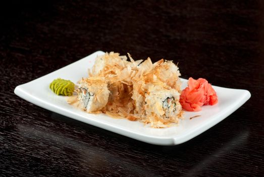 Sushi rolls of rice, nori, cream cheese, avocado, smoked salmon,cucumber and cuts of tuna