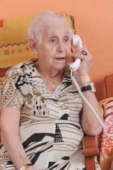 senior woman talking on the phone in a  retirement facility