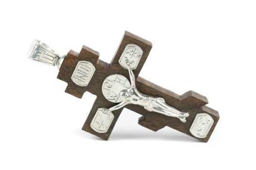silver and wooden cross with religious inscriptions isolated on a white